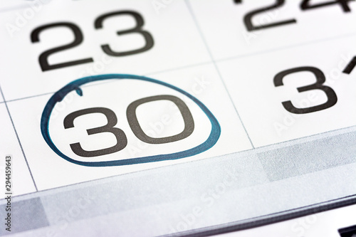 Obraz na płótnie the thirtieth day of the month highlighted on the calendar close-up macro, the m