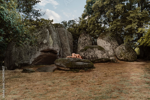 Nude woman lying on a rock at Beglik Tash prehistoric rock sanctuary, Bulgaria