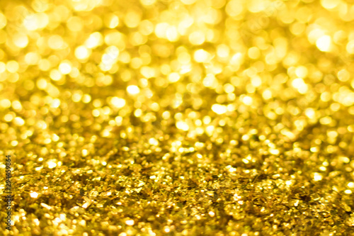 Gold glitter texture. Festive sparkling sequins background. Wpaper for Valentine, New Year or Christmas Holidays.