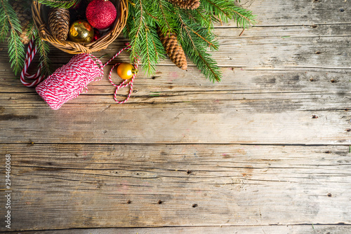 Christmas greeting background with Christmas tree branches, traditional decorations, gifts and xmas balls. Classic wooden background, top view flat lay copy space photo