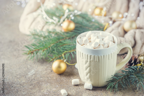 A cup of hot chocolate with marshmallows on a Christmas background