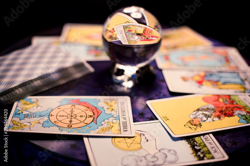 Tarot cards spread on a table surrounding crystal ball photo