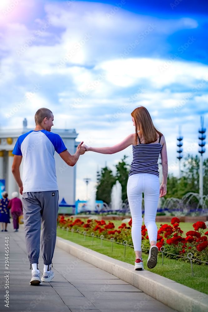 holidays, vacation, love and friendship concept - smiling couple having fun in the background of a city park, fountains holidays, vacation, love and friendship concept - smiling couple having fun in the background of a city park, fountains