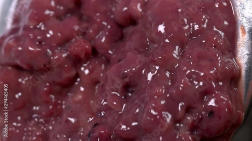 pieces of the liver come out through the holes in the meat grinder when scrolling, it looks very nasty and it looks like the human intestines are scrolling, close-up