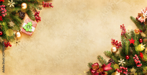 Xmas presents with lights, decoration and fir branches on vintage beige paper. Christmas or new year background for your design. photo