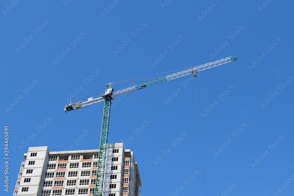 Bottom view of the multi-storey house and construction crane.