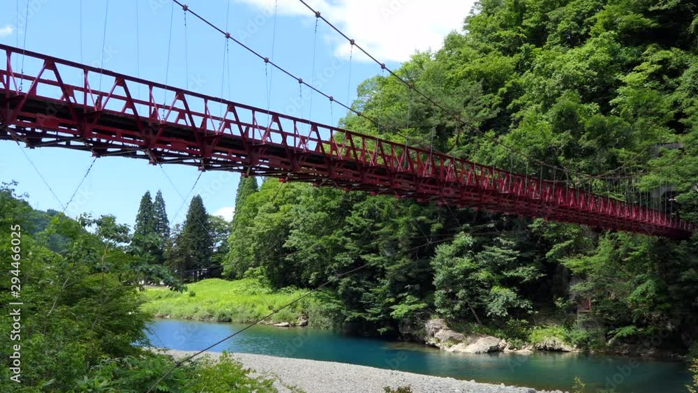 View of Dakigaeri Gorge or Dakigaeri Valley in Akita Prefecture, Japan, Asia. Popular Japanese tourist spot and travel destination with supsension bridge, forest, trees, river with crystal clear water View of Dakigaeri Gorge or Dakigaeri Valley in Akita Prefecture, Japan, Asia. Popular Japanese tourist spot and travel destination with supsension bridge, forest, trees, river with crystal clear water
