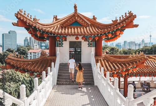 Woman and man standing outside temple