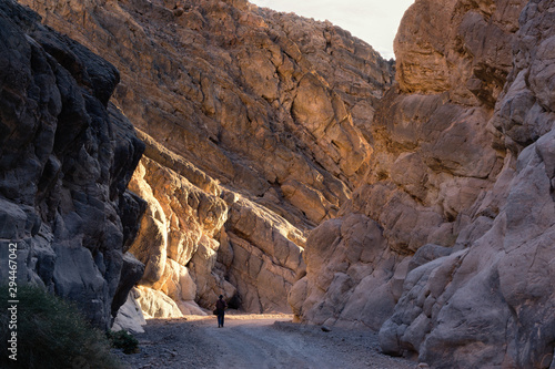 Photographer hiking in Titus Canyon at sunset at Death Valley National Park, CA, USA