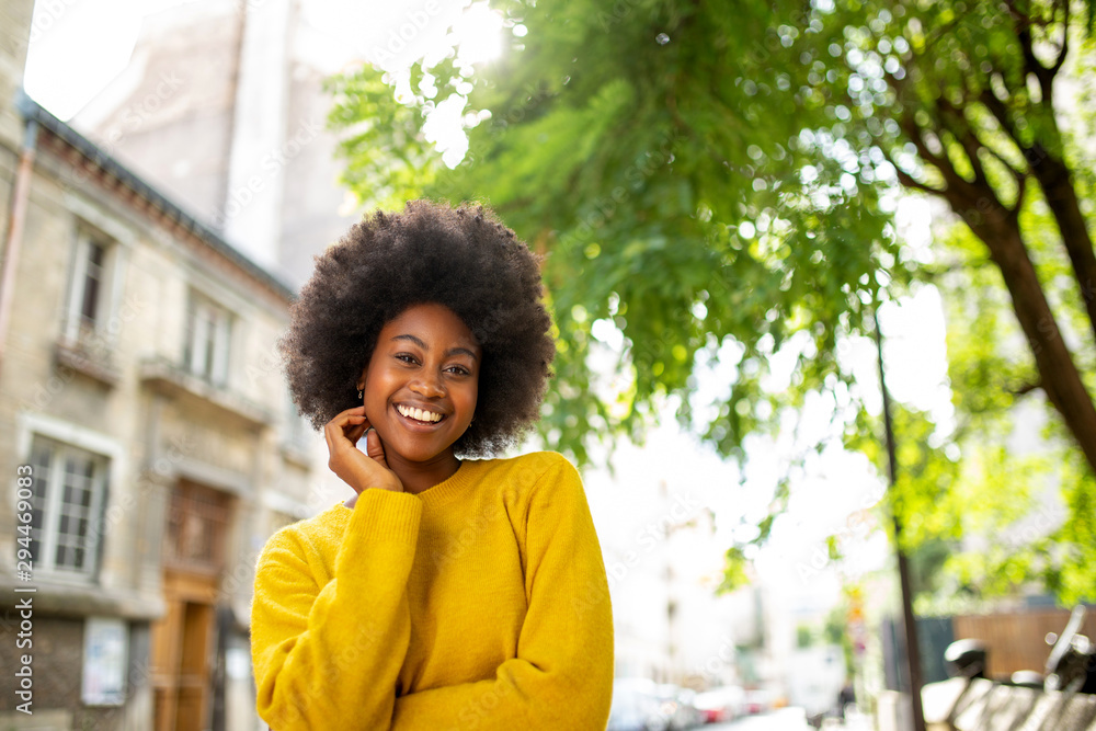 smiling young afro american woman standing outside smiling young afro american woman standing outside