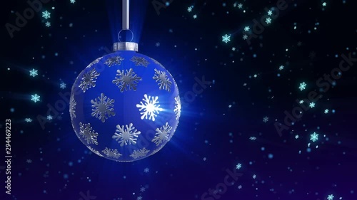 Blue Christmas  tree ball rotates on a background of falling snow. looped movement