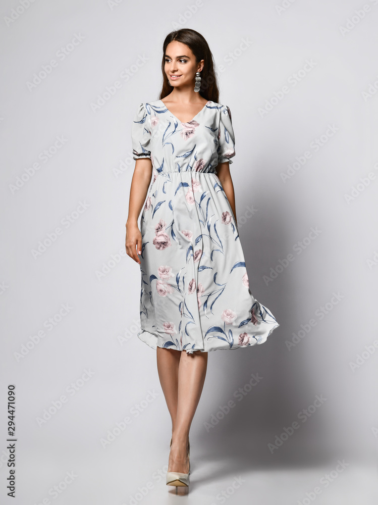 Spectacular girl in a delicate flying dress with a full-length rose pattern Spectacular girl in a delicate flying dress with a full-length rose pattern