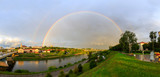 Panoramic view of the city of Grodno, the embankment, the Neman river and the old city. Autumn evening, the city in the sunshine against a background of dark clouds and a rainbow