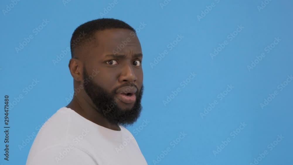 Close-up portrait of handsome attractive manly shocked guy in white t-shirt, opened mouth, isolated over bright vivid blue background 4K Close-up portrait of handsome attractive manly shocked guy in white t-shirt, opened mouth, isolated over bright vivid blue background 4K