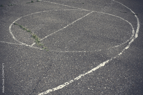 Old asphalt basketball court. Close-up. Top view. Background. Texture.