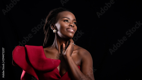 Canvastavla Beautiful close up shot of woman african wearing red dress face with make up fashion, shooting studio shot isolated on black background