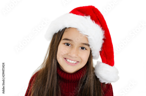  Beautiful little girl in red Santa hat. Isolated on white background 