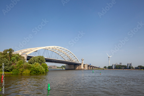 Van Brienenoord Bridge in Rotterdam over the river Nieuwe Maas seen from the north bank on the east side. The two arch bridges, part of the A16 motorway, were completed in 1965 and 1990 respectively. photo