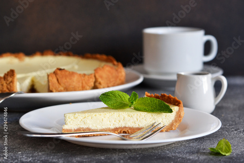 Cheesecake slice on a white plate. Close-up