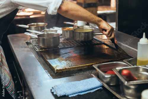 The cook who cleans the kitchen after work