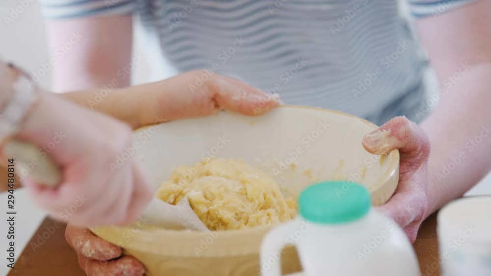 Close Up Of Young Downs Syndrome Couple Mixing Ingredients For Cake Recipe In Kitchen At Home Close Up Of Young Downs Syndrome Couple Mixing Ingredients For Cake Recipe In Kitchen At Home