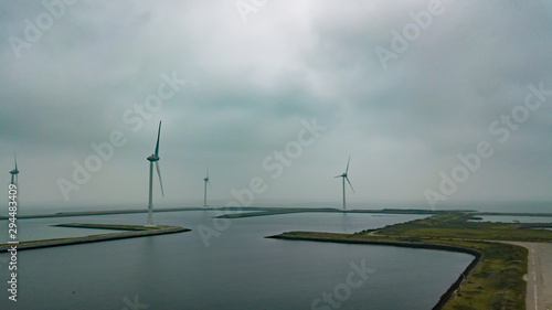Aerial view of several wind turbines in Holland on the Oosterschelde. Misty and overcast weather.