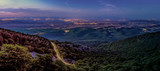 Mountains panorama landscape with lights of villages at night 