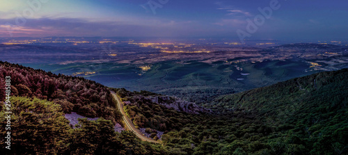 Mountains panorama landscape with lights of villages at night 