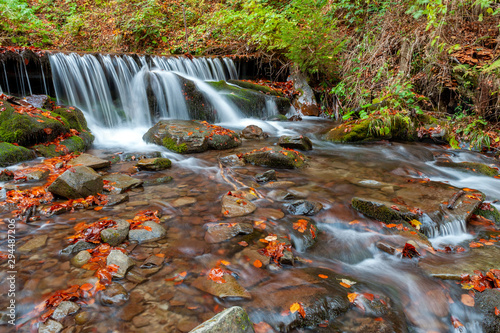 Mountain waterfall in autumn forest