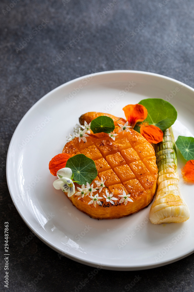 Roast pumpkin dish with leek and garlic flowers Roast pumpkin dish with leek and garlic flowers