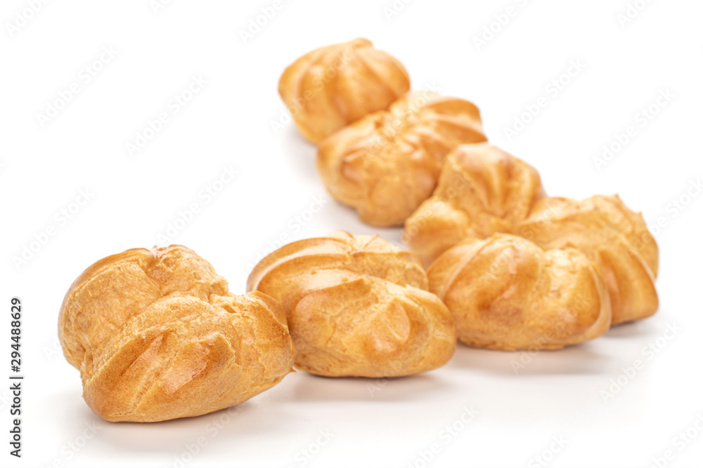 Group of seven whole baked golden profiterole triangle isolated on white background Group of seven whole baked golden profiterole triangle isolated on white background