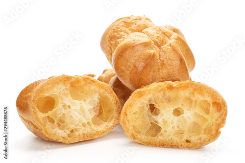 Group of two whole two halves of baked golden profiterole isolated on white background photo