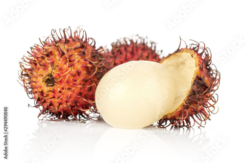 Group of three whole one half of fresh red rambutan one peeled isolated on white background