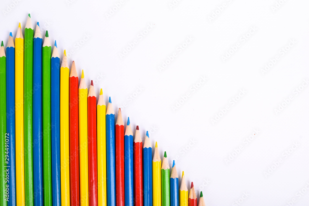 Fototapeta premium Many different colored pencils on a white background with a place for text and cory space .