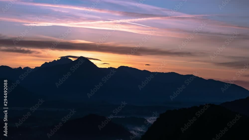 Time-lapse view on the beautiful sunrise over the majestic hills with the Lake Bled in Slovenia on a cold foggy morning. Time-lapse view on the beautiful sunrise over the majestic hills with the Lake Bled in Slovenia on a cold foggy morning.