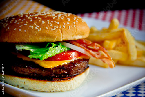 Classic cheese hamburger with grilled beef and toasted bun, close-up. photo