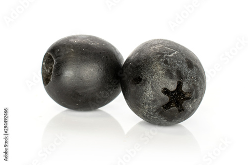 Group of two whole tasty black olive isolated on white background