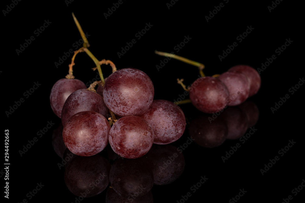Group of nine whole fresh purple grape rose isolated on black glass Group of nine whole fresh purple grape rose isolated on black glass