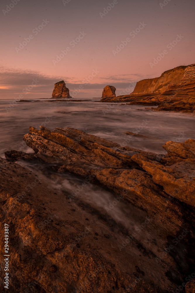 Long exposure at low tide on the rocks called two sisters of Hendaye. France, vertical photography