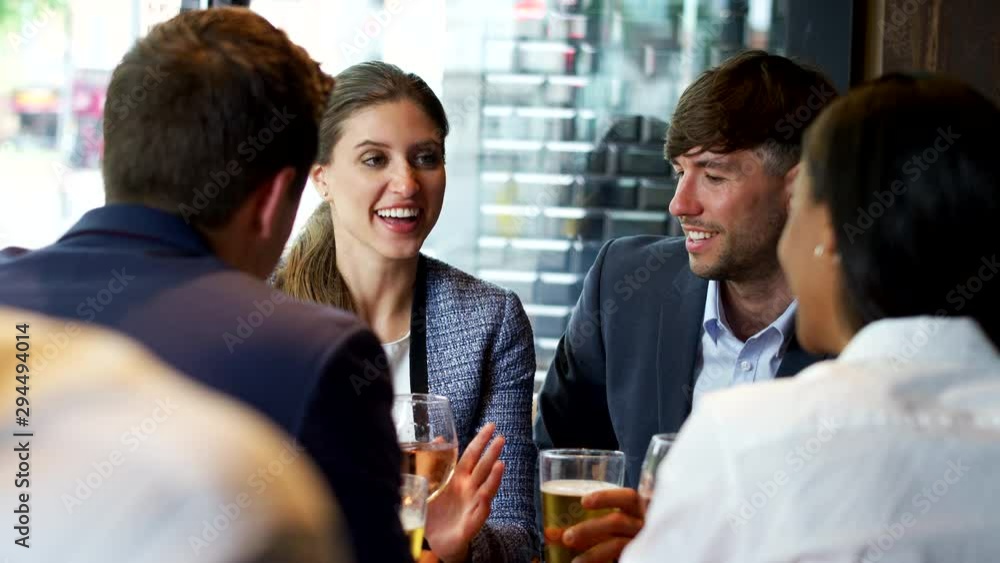 Group Of Business Colleagues Meeting For Drinks And Socializing In Bar After Work Group Of Business Colleagues Meeting For Drinks And Socializing In Bar After Work