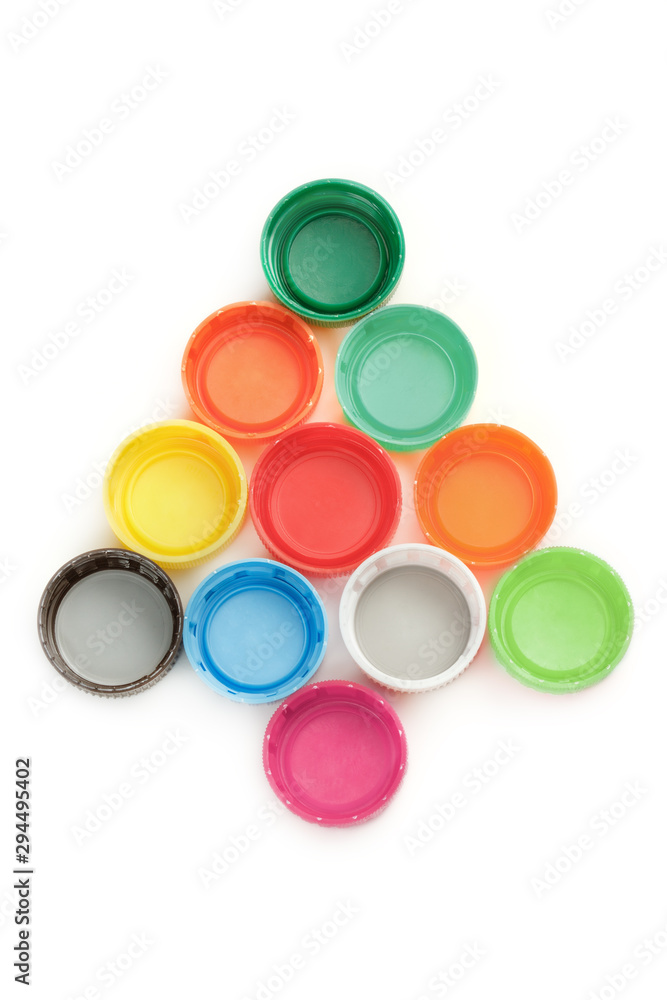 Colorful plastic bottle screw caps arranged in Christmas tree shape on white Colorful plastic bottle screw caps arranged in Christmas tree shape on white