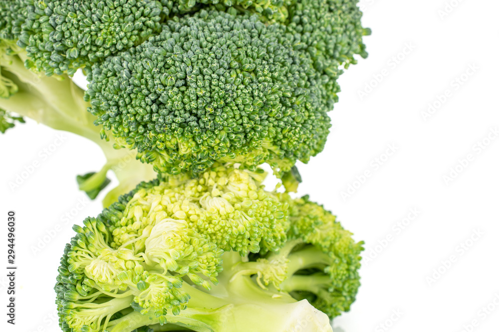 Group of two whole light fresh green broccoli front focus isolated on white background Group of two whole light fresh green broccoli front focus isolated on white background