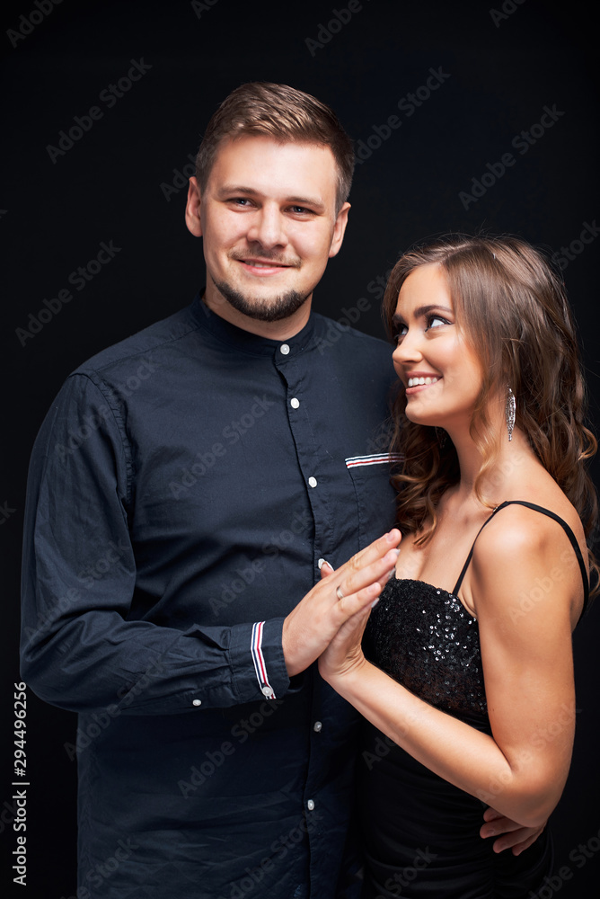 Portrait of young couple in elegant evening clothes isolated on black background. Portrait of young couple in elegant evening clothes isolated on black background.