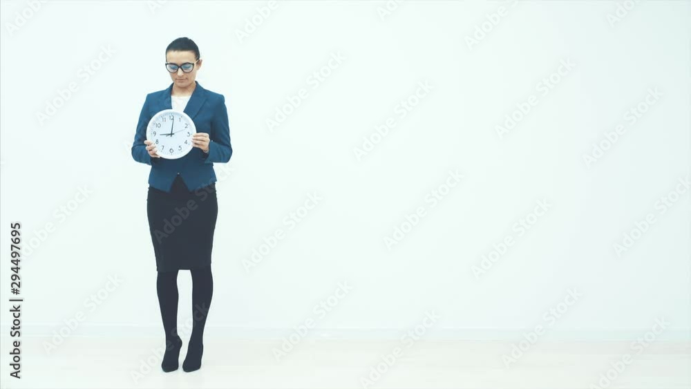 Portrait of beautiful young business woman holding in hands clock, isolated on white background, discipline and punctual concept Portrait of beautiful young business woman holding in hands clock, isolated on white background, discipline and punctual concept
