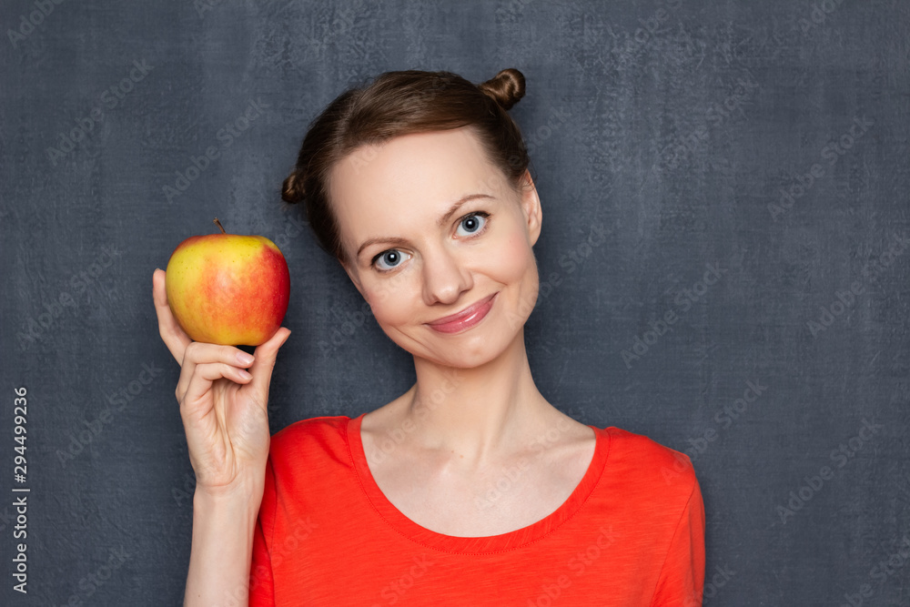 Portrait of cute happy girl holding ripe yellow-red apple Portrait of cute happy girl holding ripe yellow-red apple