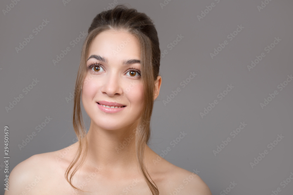 Portrait of a beautiful woman. Lovely smile on a gray background Portrait of a beautiful woman. Lovely smile on a gray background