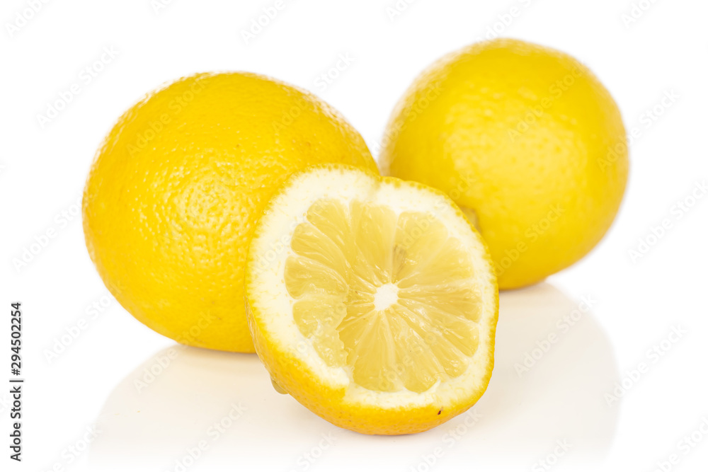 Group of two whole one half of fresh yellow lemon isolated on white background