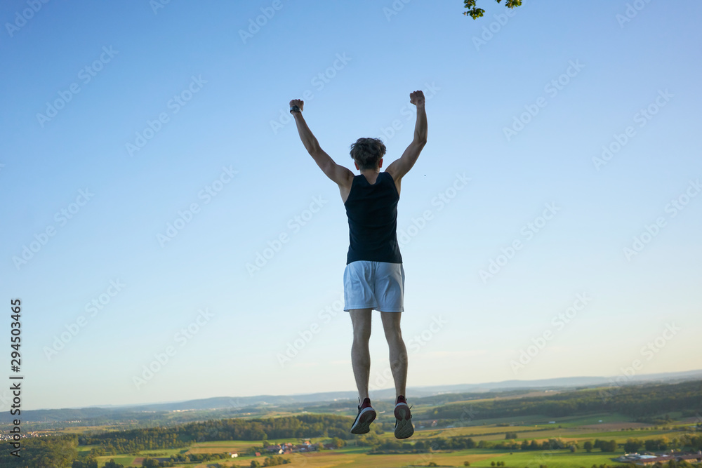 sporty man jumping both arms rising winner sporty man jumping both arms rising winner