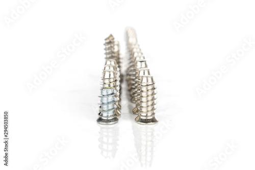 Lot of whole metallic glossy bolt in row isolated on white background