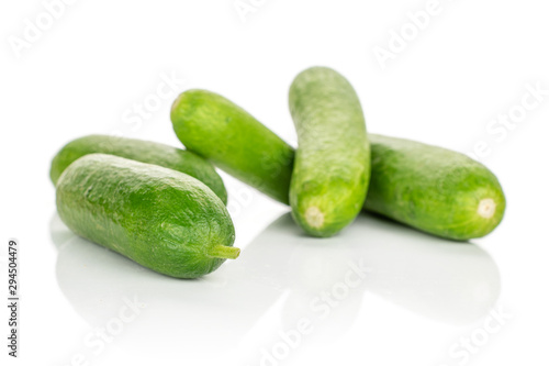 Group of five whole mini green cucumber isolated on white background
